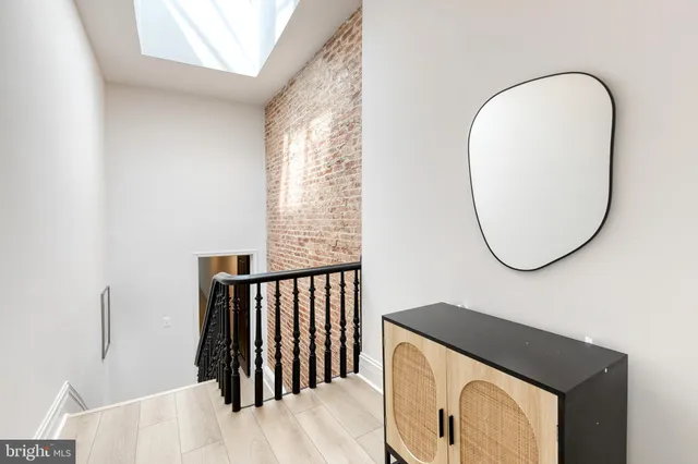 a view of a hallway view with wooden floor and staircase