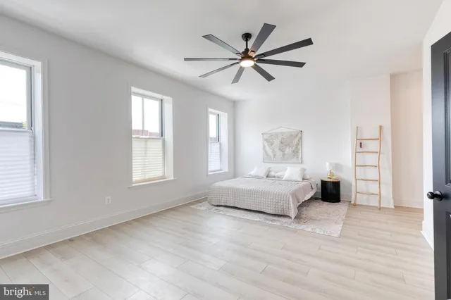 a kitchen with a table chairs and a refrigerator