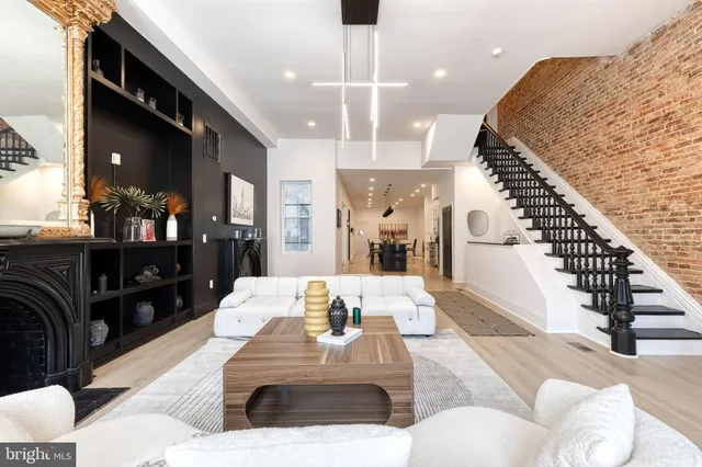 a living room with furniture a rug and a fireplace