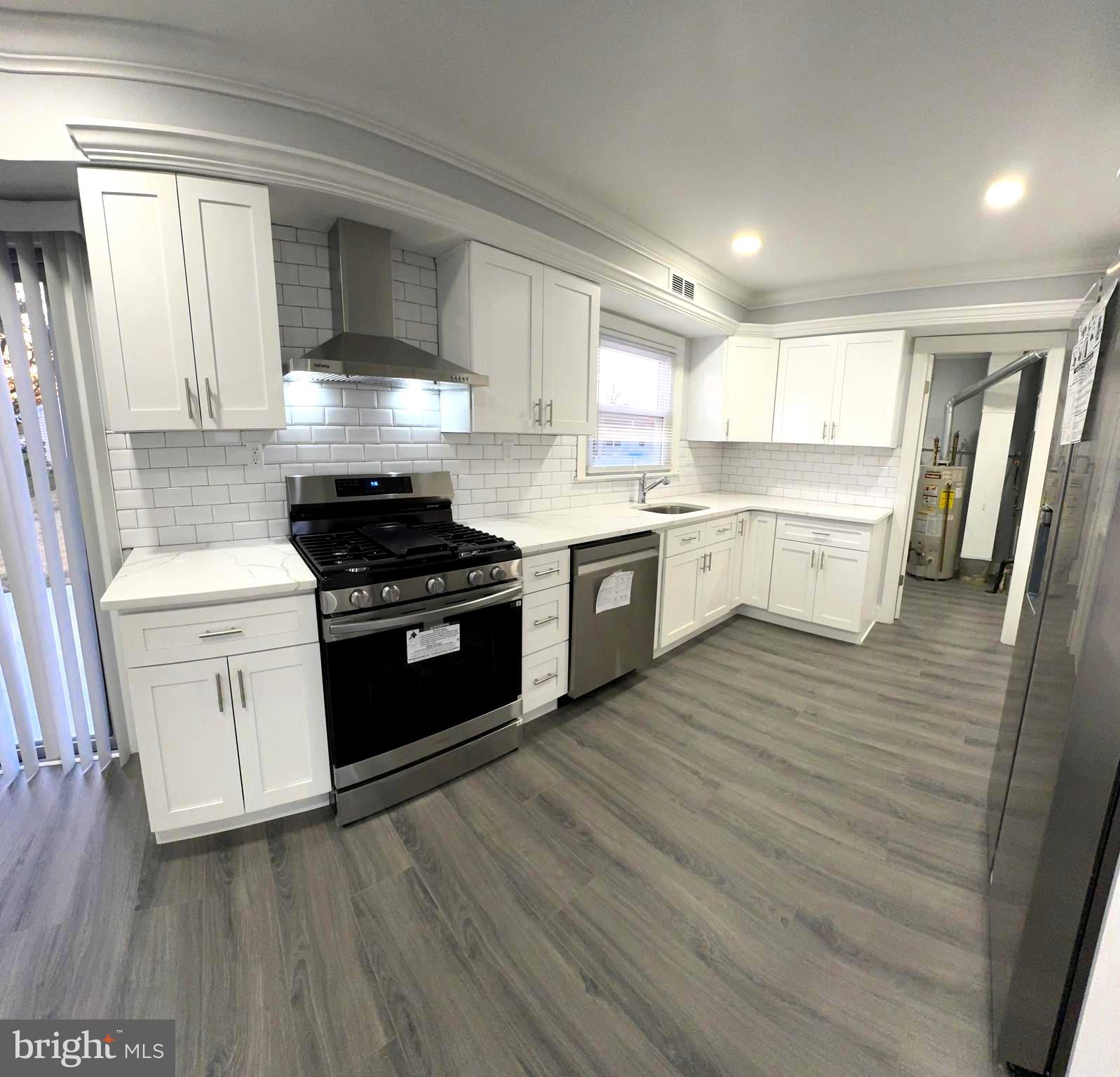 18 Grayson Circle Willingboro, NJ 08046 - Photo 23 of 57 a kitchen with a stove top oven cabinets and wooden floor