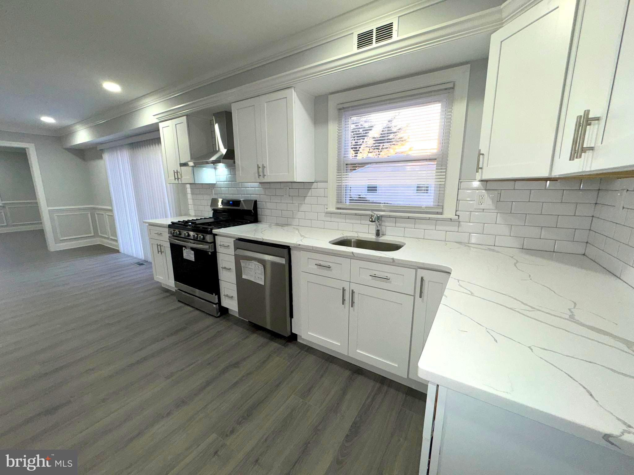 18 Grayson Circle Willingboro, NJ 08046 - Photo 27 of 57 a kitchen with a sink wooden floor and a stove