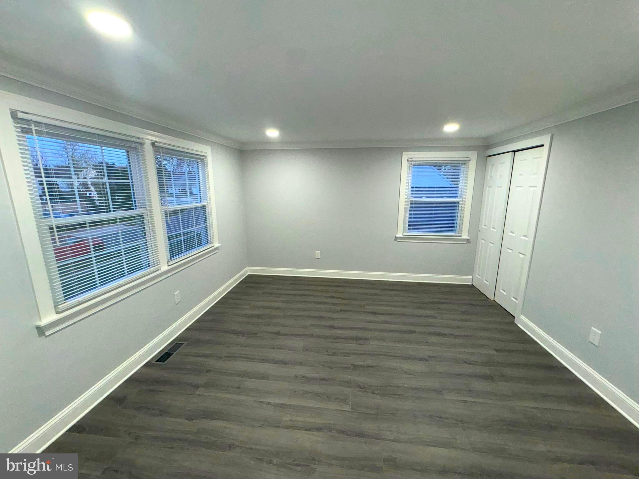 18 Grayson Circle Willingboro, NJ 08046 - Photo 34 of 57 a view of an empty room with wooden floor and windows