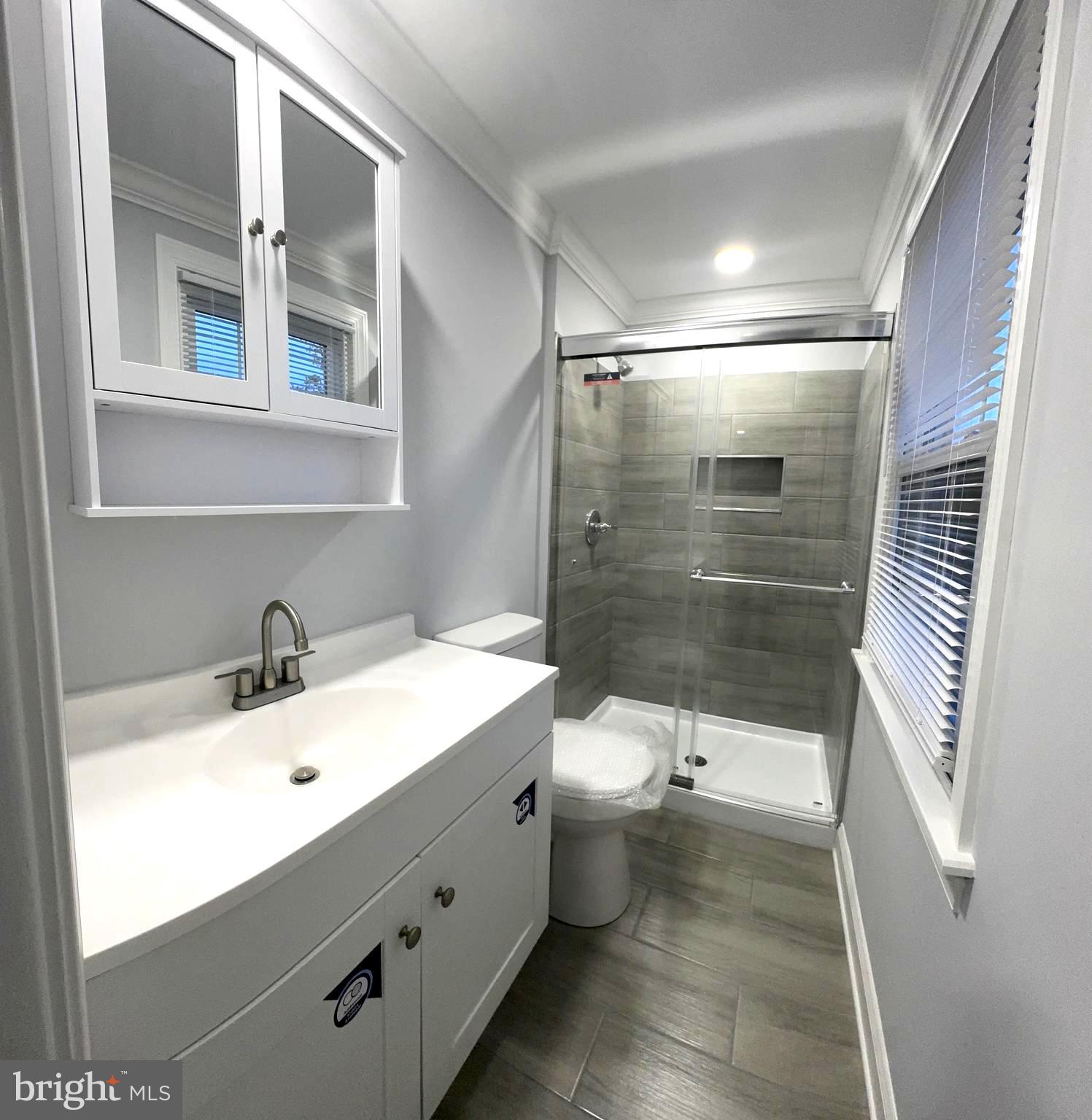 18 Grayson Circle Willingboro, NJ 08046 - Photo 36 of 57 a bathroom with a sink mirror vanity and toilet