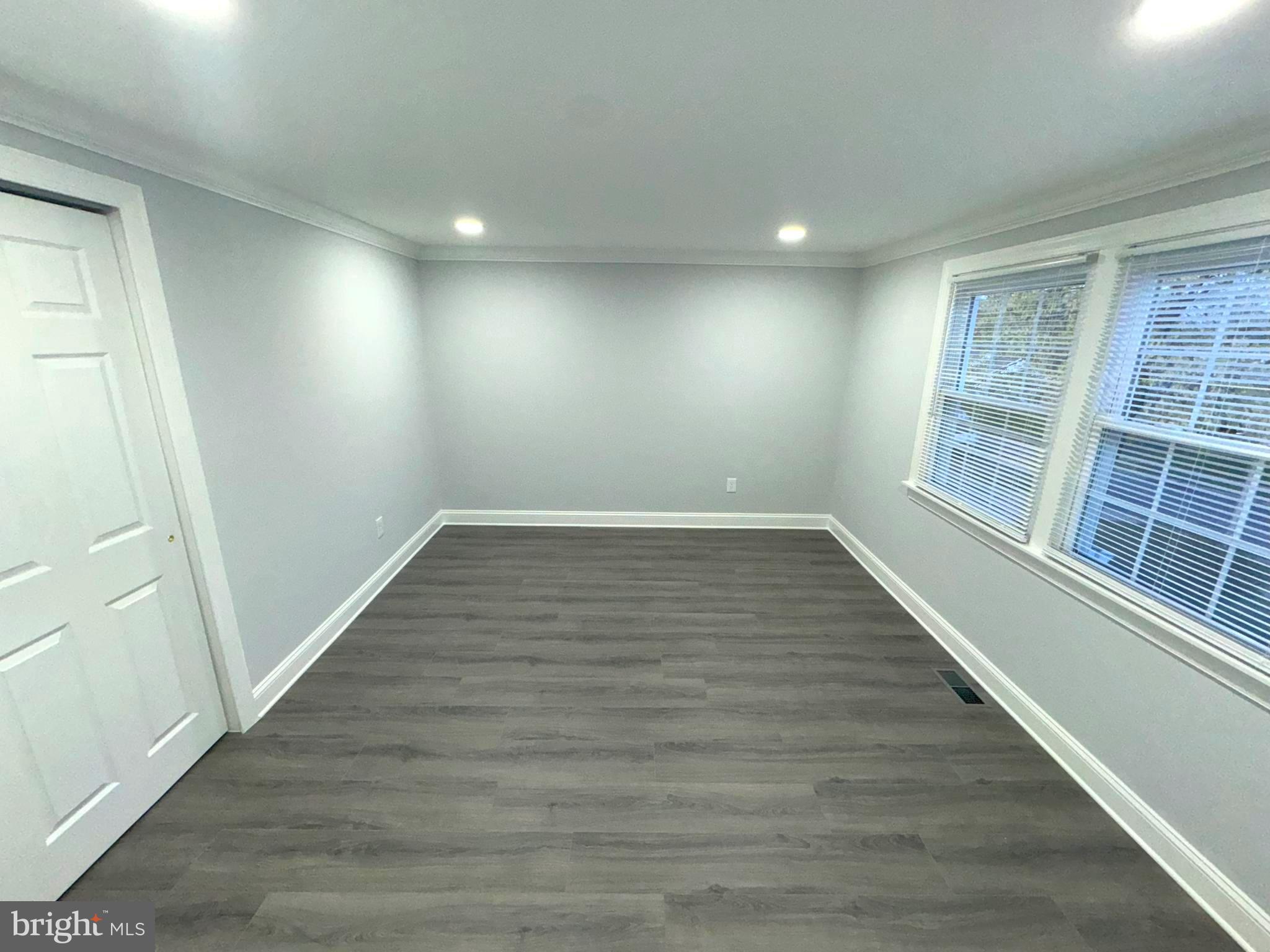 18 Grayson Circle Willingboro, NJ 08046 - Photo 43 of 57 an empty room with wooden floor and windows