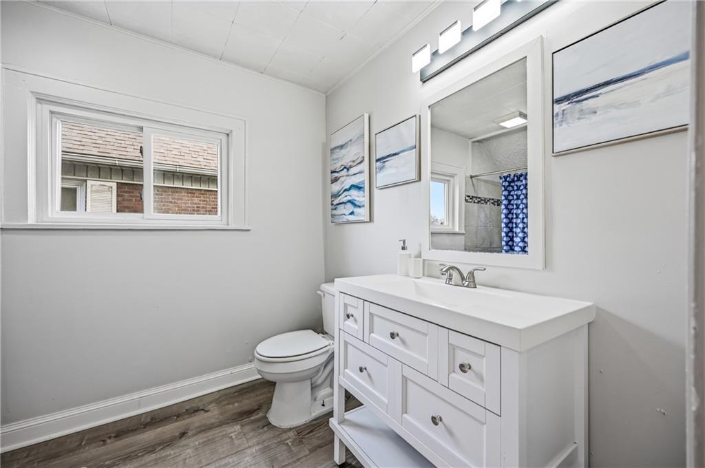 368 Stambaugh Avenue Sharon, PA 16146 - Photo 26 of 43 a bathroom with a sink a toilet and a mirror