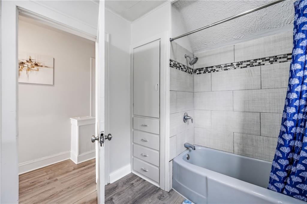 368 Stambaugh Avenue Sharon, PA 16146 - Photo 27 of 43 a bathroom with a bathtub and a shower