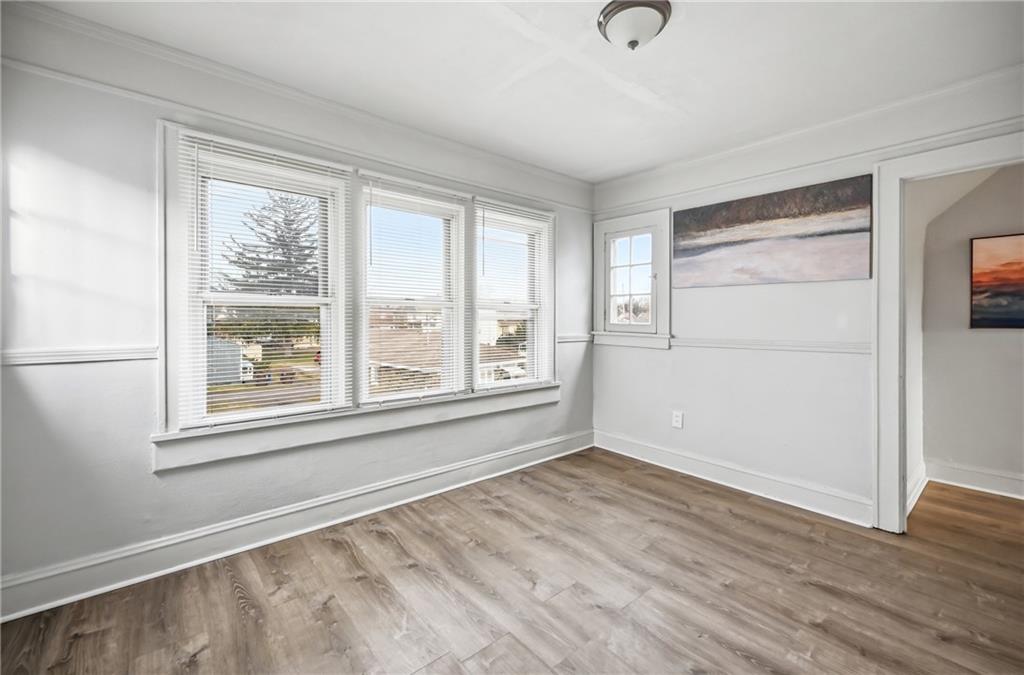 368 Stambaugh Avenue Sharon, PA 16146 - Photo 30 of 43 a view of an empty room with wooden floor and a window