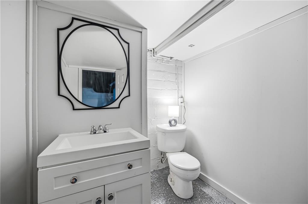 368 Stambaugh Avenue Sharon, PA 16146 - Photo 36 of 43 a bathroom with a toilet sink and mirror