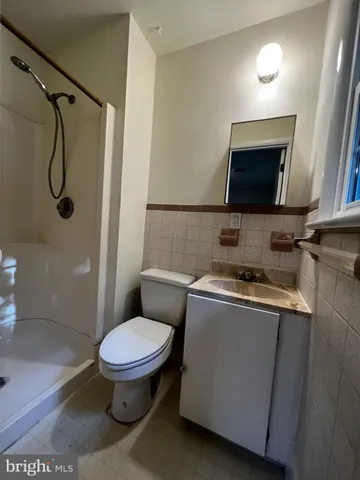 a bathroom with a toilet sink and shower
