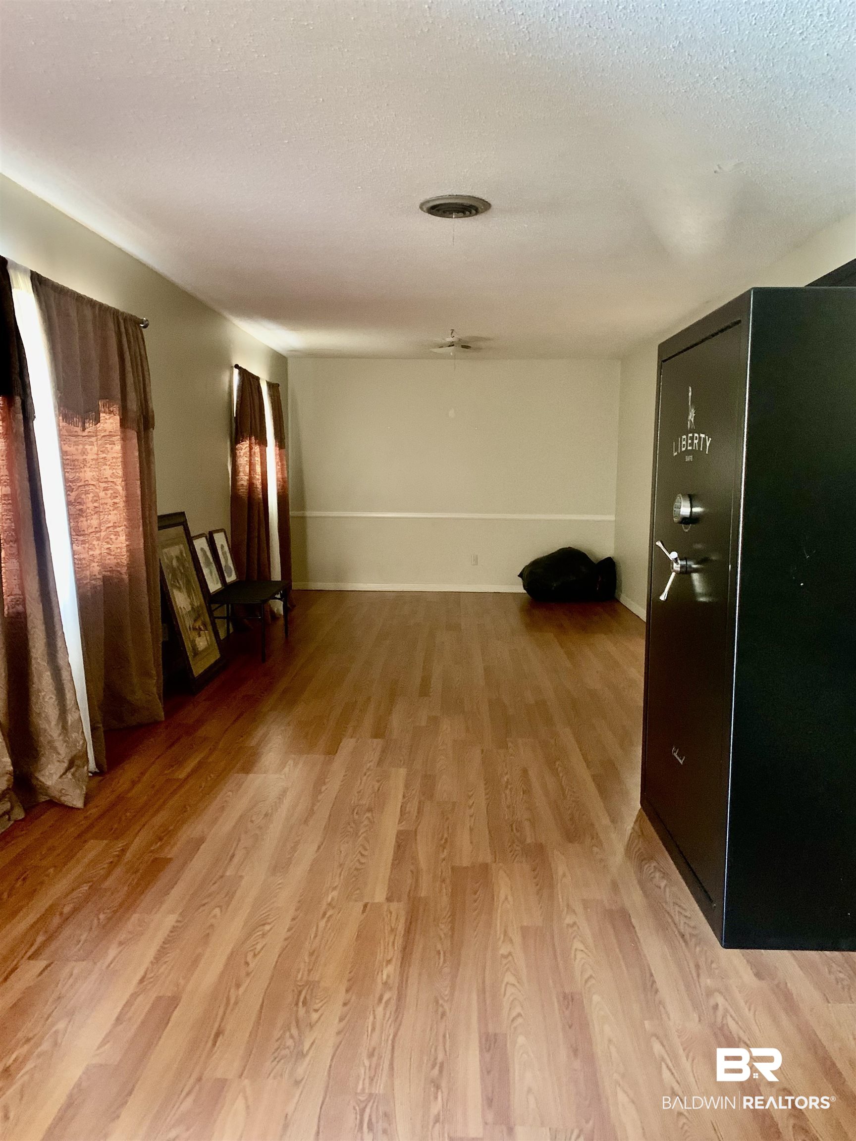 5467 Racine Avenue Mobile, AL 36618 - Photo 4 of 11 Spare room with light hardwood / wood-style floors and a textured ceiling