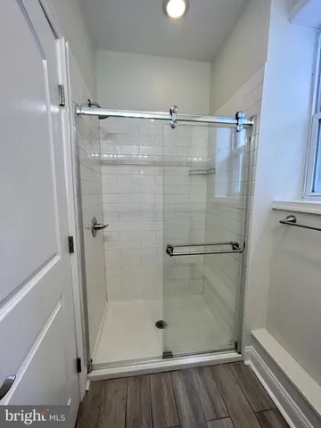 a bathroom with a glass door shower