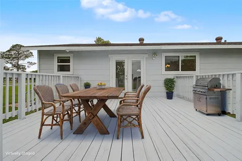a view of a house with patio and wooden floor