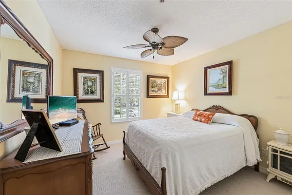 a bedroom with a bed gym equipment and a window
