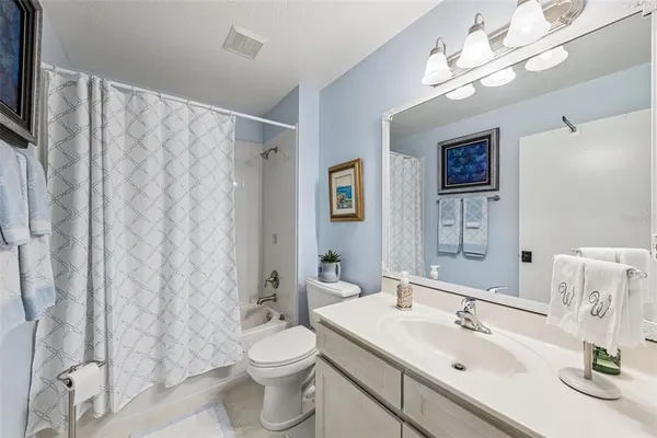 a bathroom with a sink toilet a mirror and shower