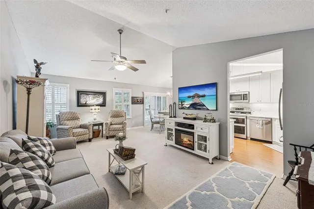 a living room with furniture a flat screen tv and a stove