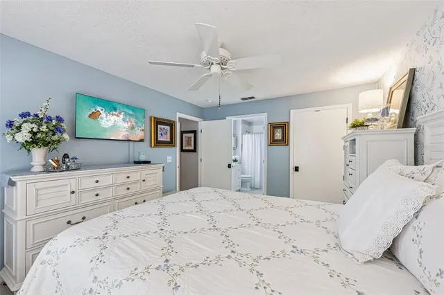 a bedroom with a large bed and a flat screen tv