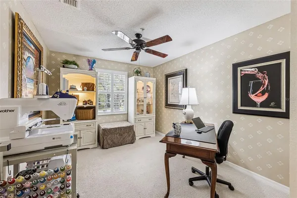 a living room with furniture and paintings on the wall