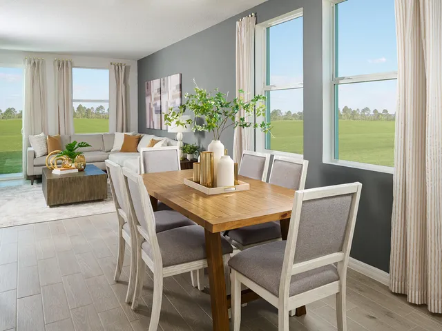 a dining room with furniture and window