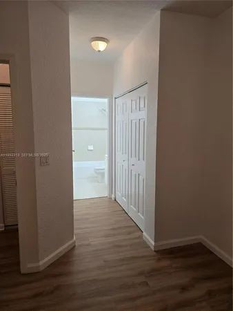 a view of a hallway with wooden floor