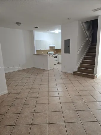 a view of kitchen with granite countertop cabinets
