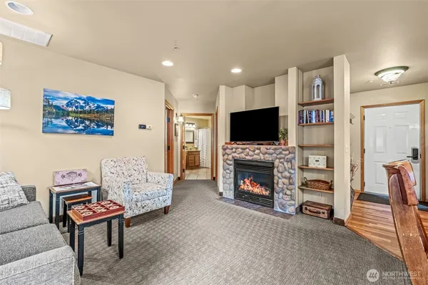 a living room with furniture a flat screen tv and a fireplace