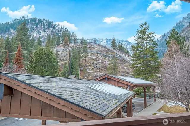 a view of a roof deck with couches and wooden floor