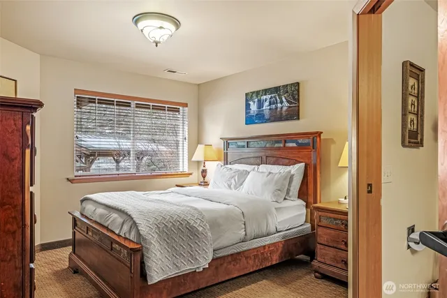 a bedroom with a bed and a night stand