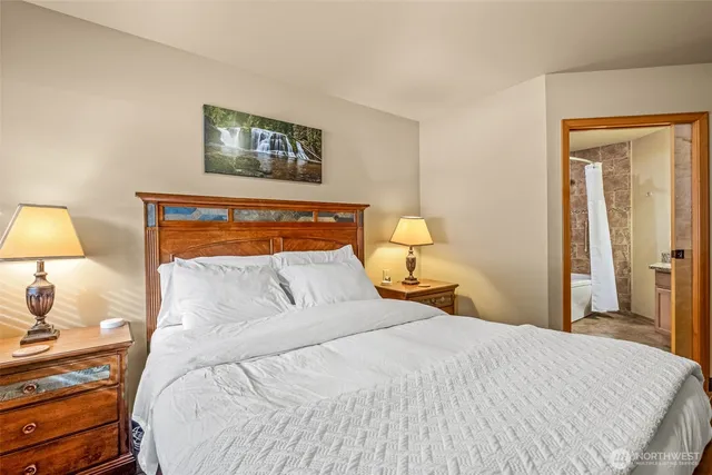 a bedroom with a bed and a lamp