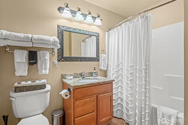a bathroom with a toilet a sink and a mirror