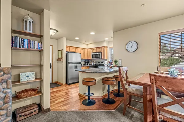 a kitchen with stainless steel appliances granite countertop a refrigerator and a stove top oven