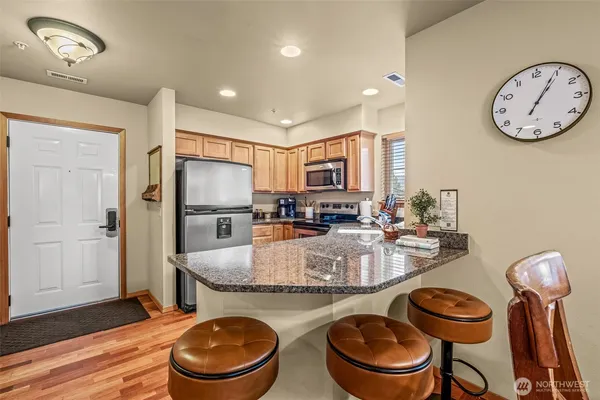 a large kitchen with a table and chairs