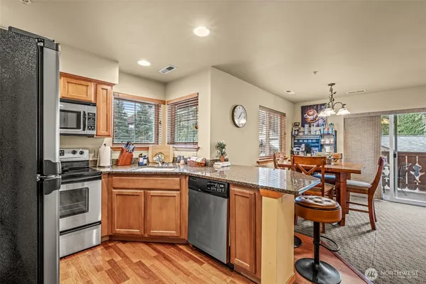 a kitchen with lots of counter top space and painting on the wall