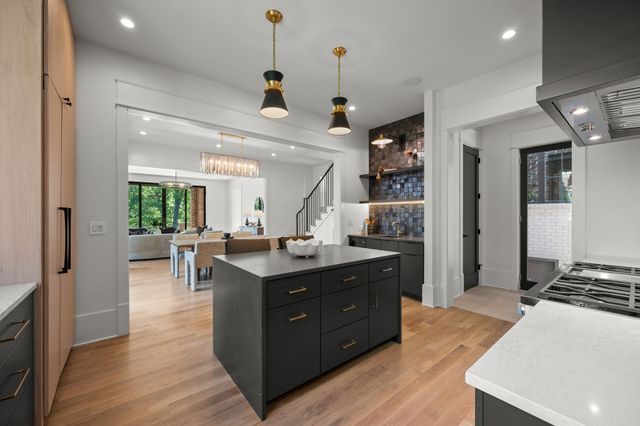 a kitchen with a sink and a stove top oven
