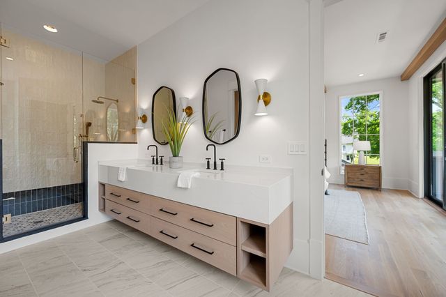 a bathroom with a double vanity sink and mirror