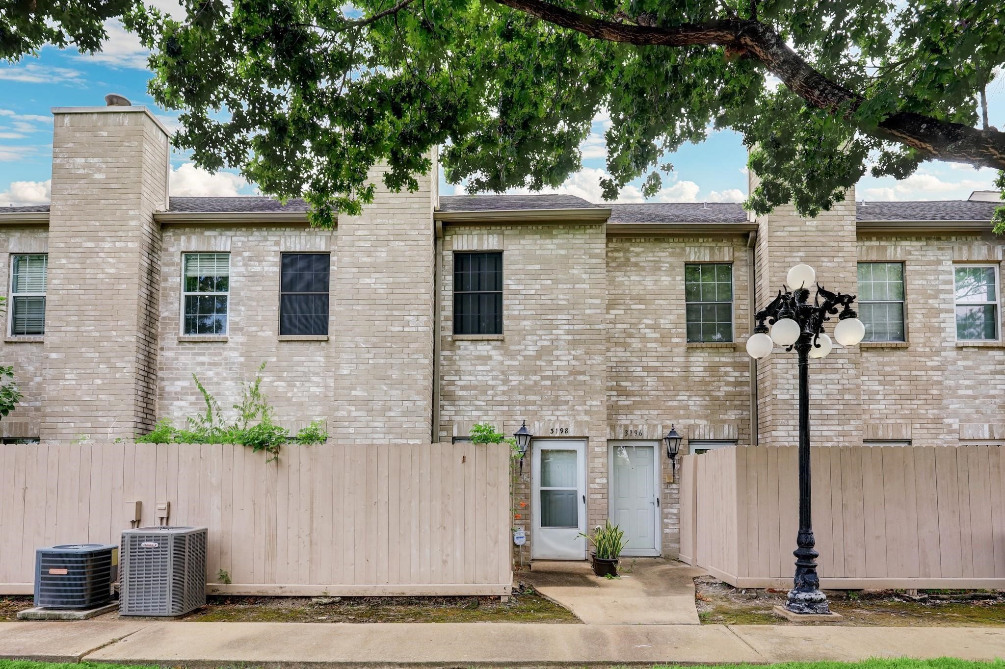 3198 Holly Hall Street, Unit 3198 Houston, TX 77054 - Photo 2 of 9 a front view of a house with trees