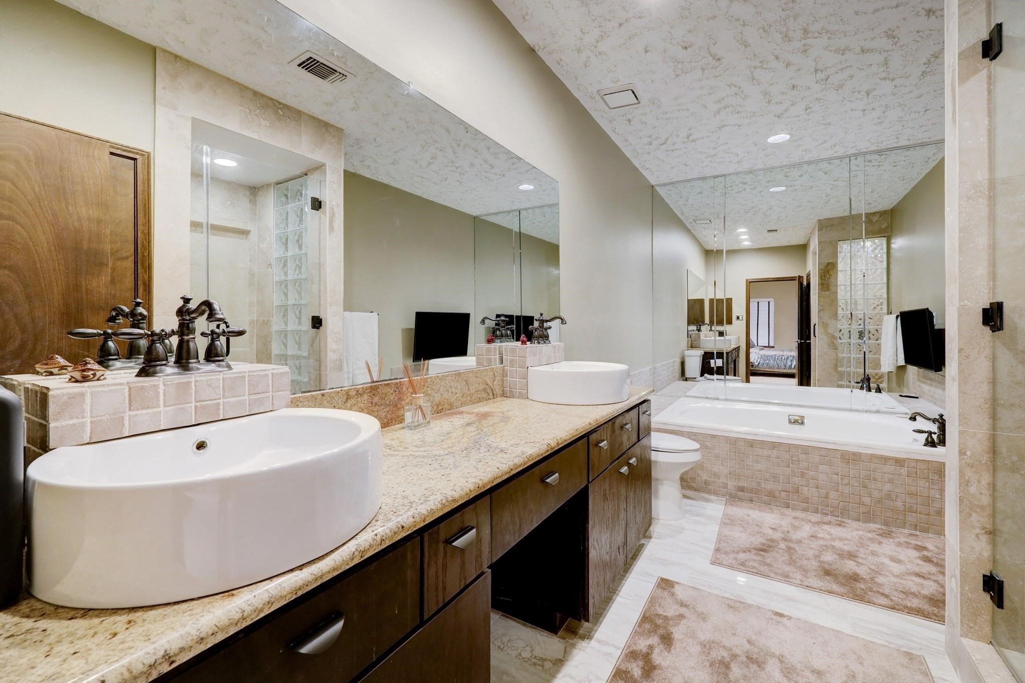3198 Holly Hall Street, Unit 3198 Houston, TX 77054 - Photo 6 of 9 a spacious bathroom with a tub sink and mirror