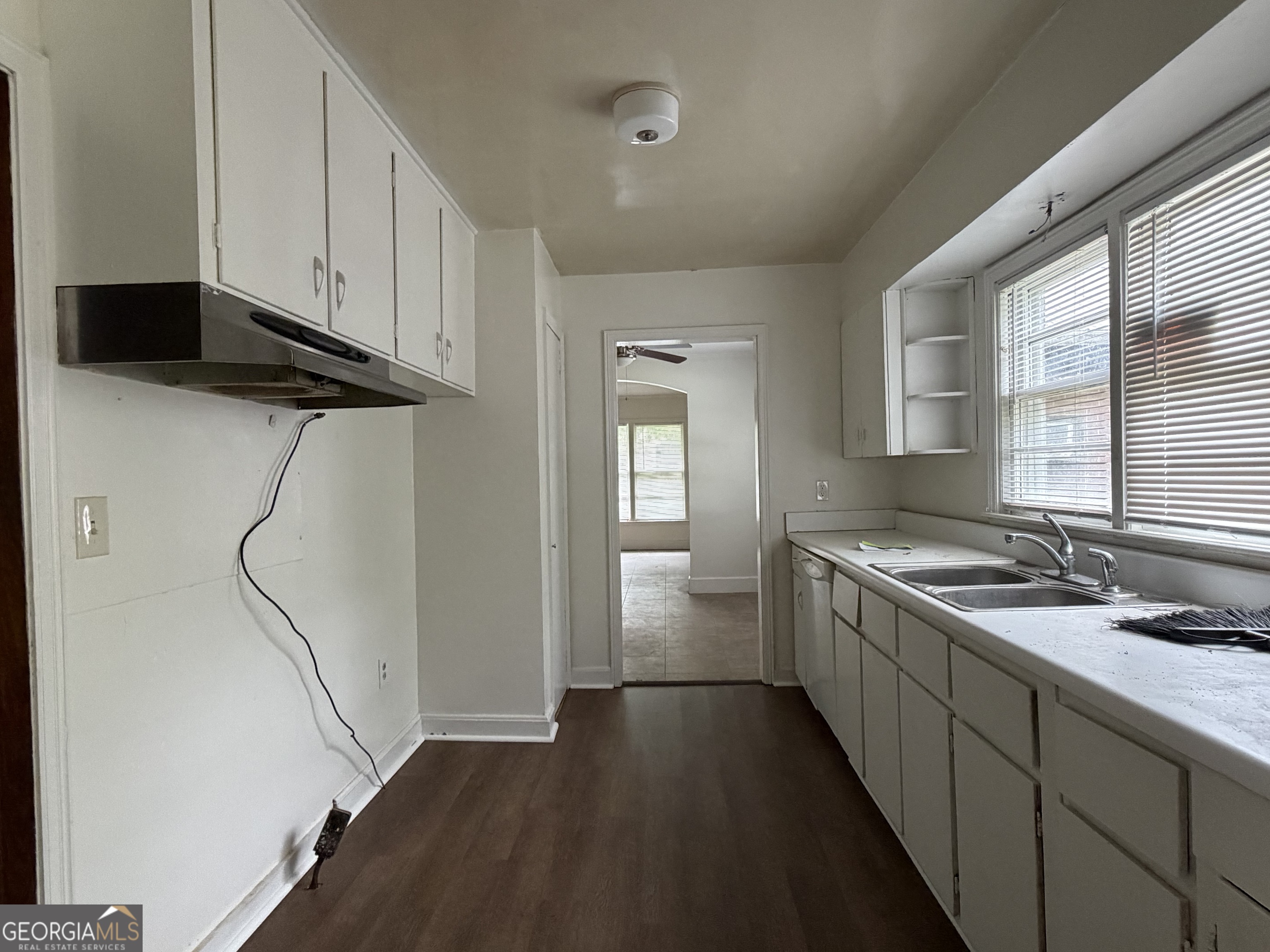 225 West Jessamine Street Fitzgerald, GA 31750 - Photo 18 of 39 a kitchen with a sink and cabinets