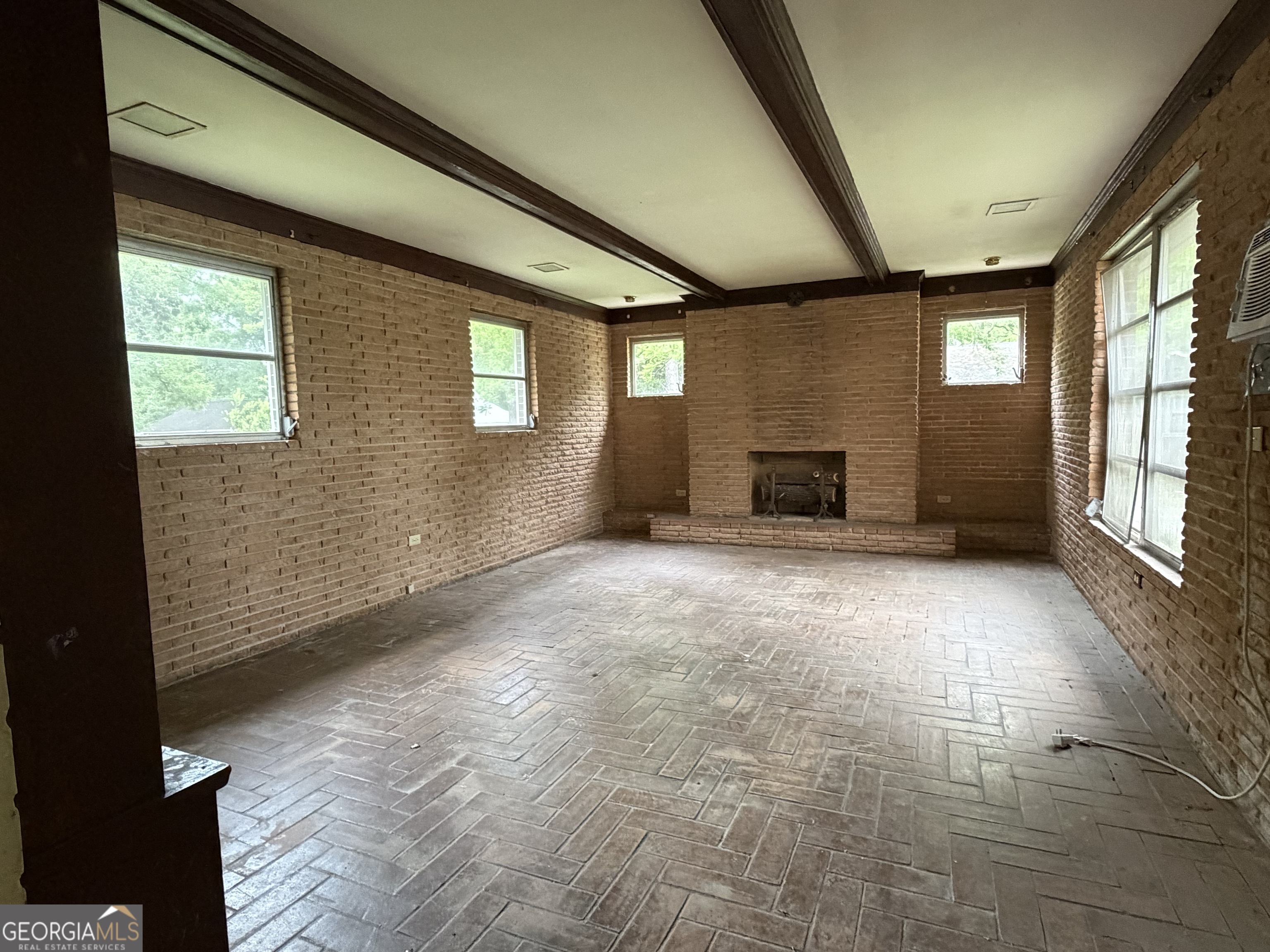 225 West Jessamine Street Fitzgerald, GA 31750 - Photo 21 of 39 a view of an empty room with a fireplace and a window