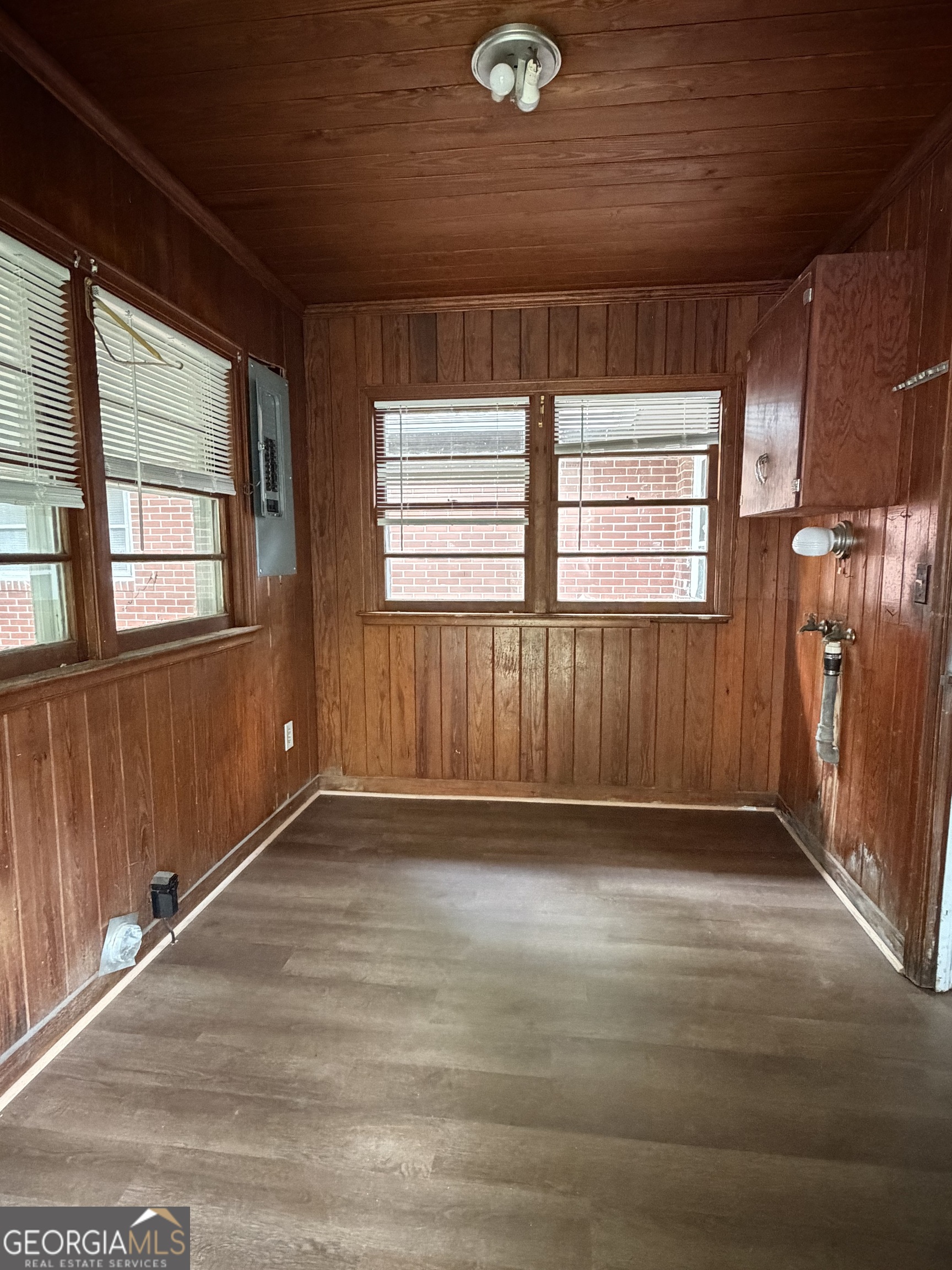 225 West Jessamine Street Fitzgerald, GA 31750 - Photo 28 of 39 an empty room with wooden floor and windows