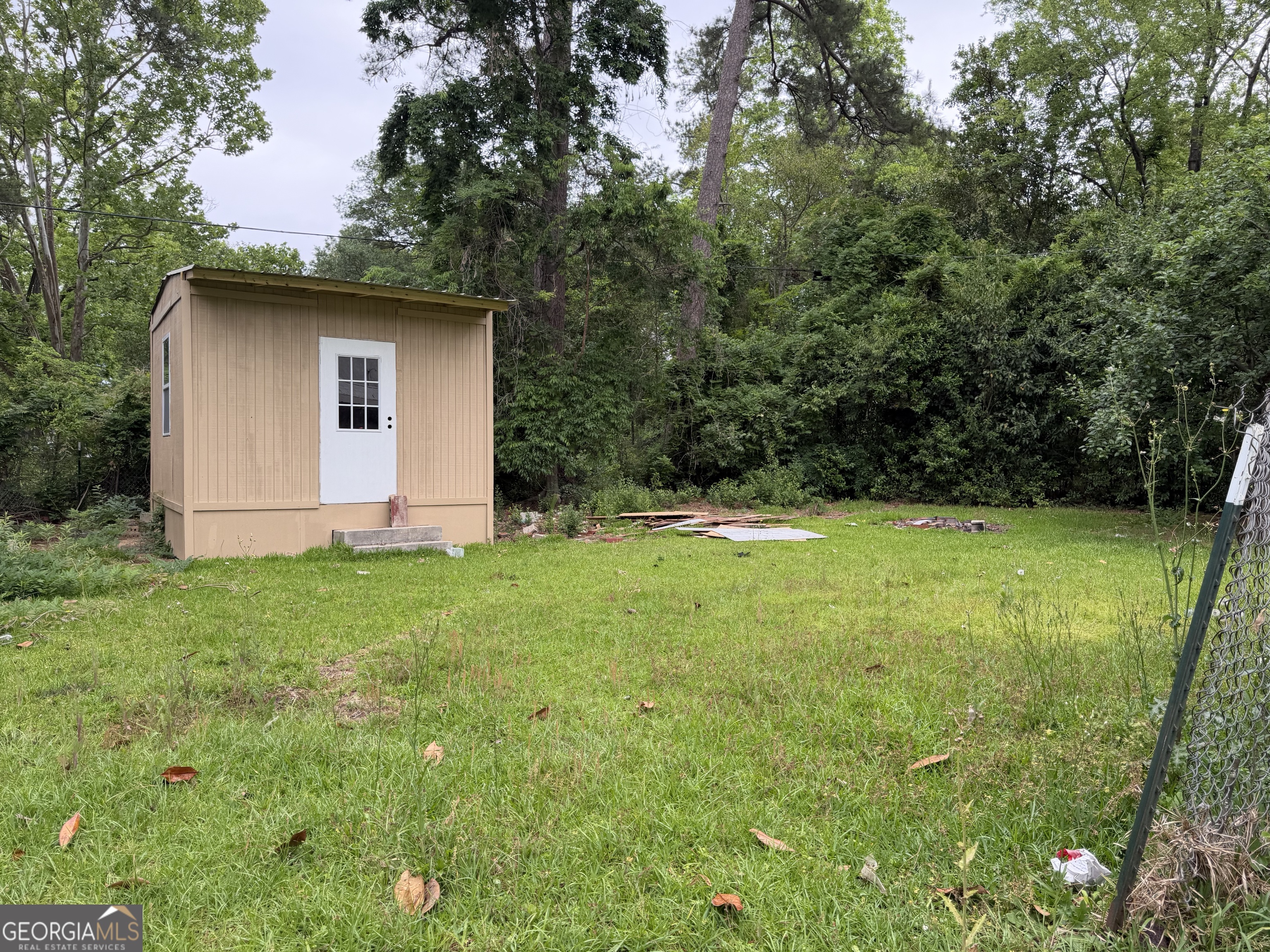 225 West Jessamine Street Fitzgerald, GA 31750 - Photo 30 of 39 a view of a backyard with barn plants and large tree