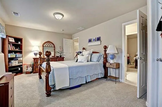 a bed room with a bed and a book shelf