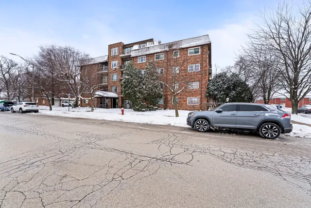 a view of a building with snow on the road