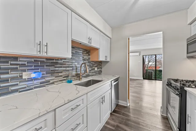 a kitchen with stainless steel appliances granite countertop a sink stove and cabinets