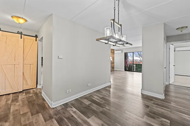 a view of a room with wooden floor staircase and a chandelier