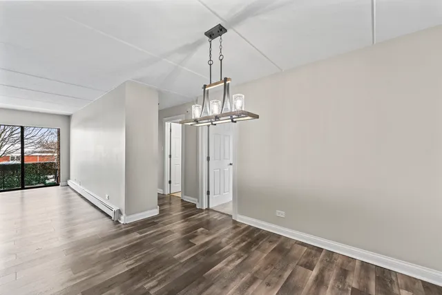 a view of a room with wooden floor entryway and windows