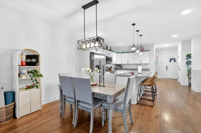 a view of a dining room with furniture and wooden floor