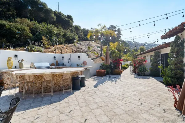 a living room with furniture a piano and a fireplace