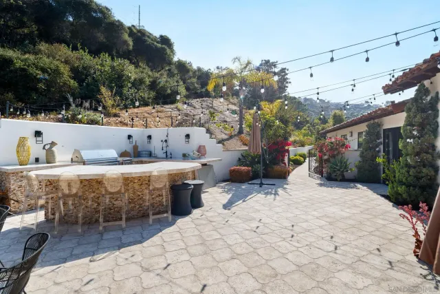 a living room with furniture a piano and a fireplace