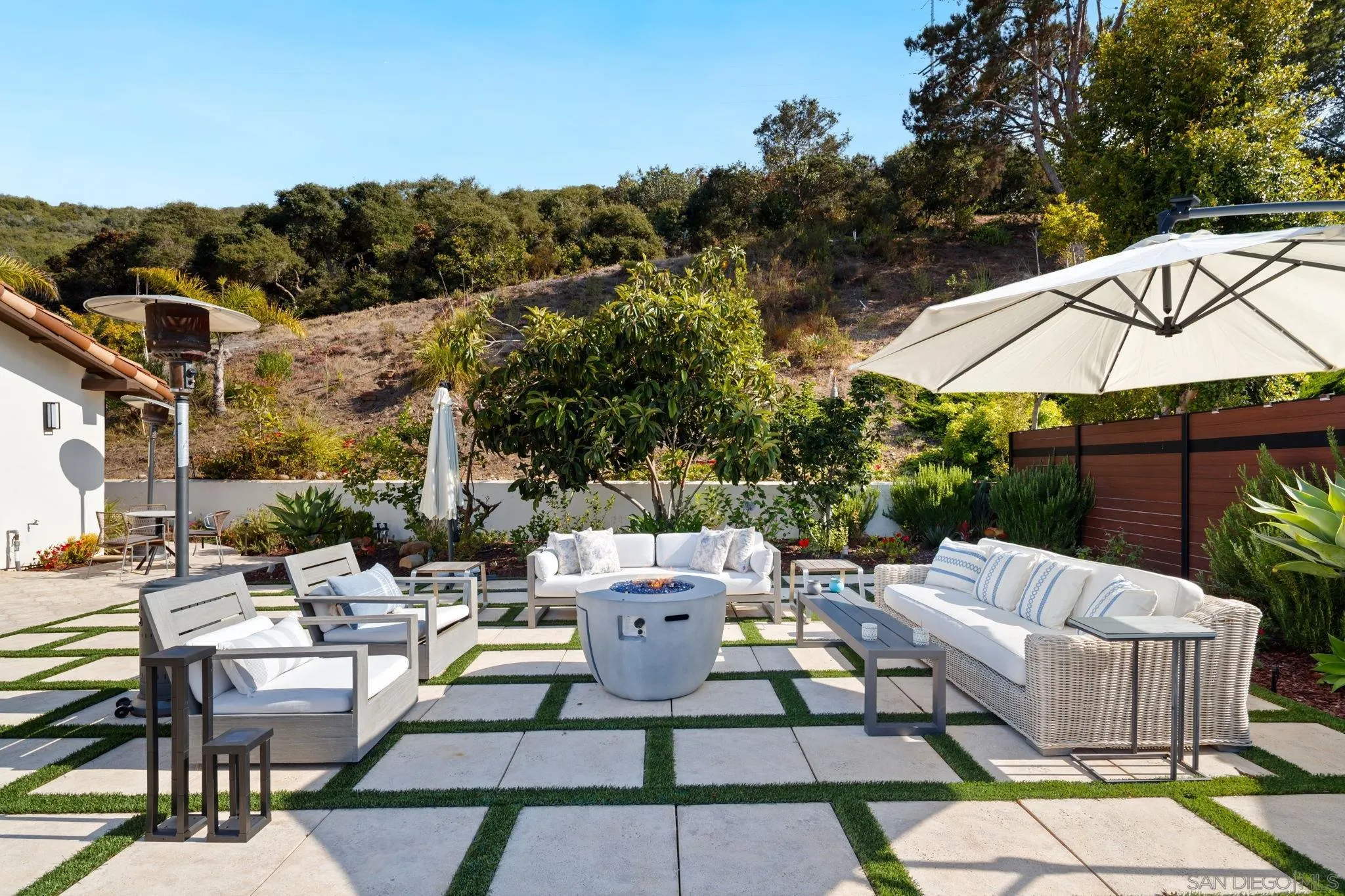 7853 Via Capri La Jolla, CA 92037 - Photo 23 of 67 a backyard of a house with table and chairs