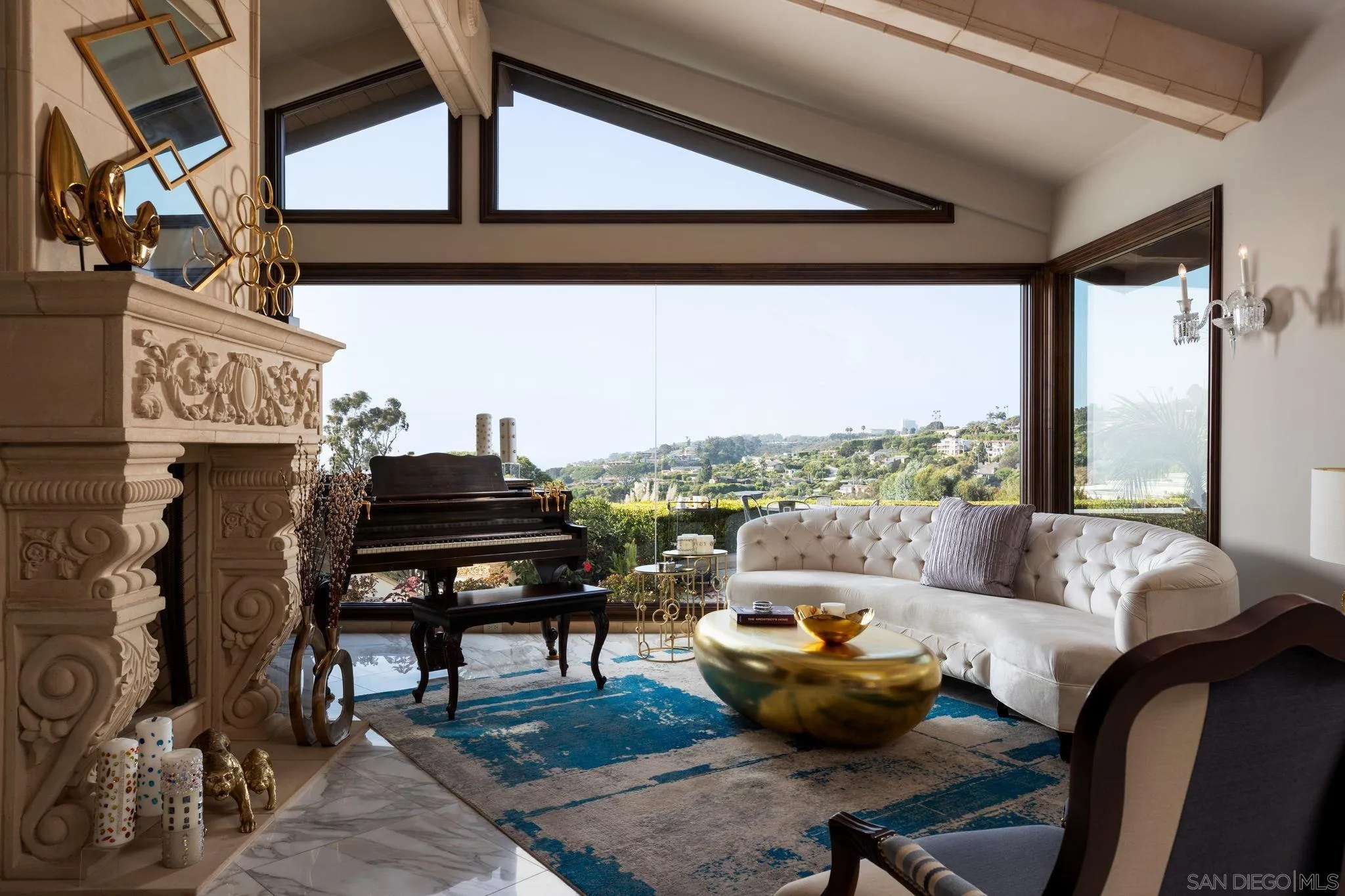7853 Via Capri La Jolla, CA 92037 - Photo 29 of 67 a living room with furniture a piano and a fireplace